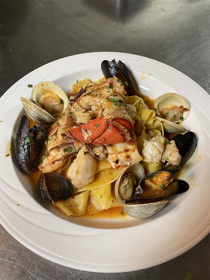Mussels, clams and lobster over pasta