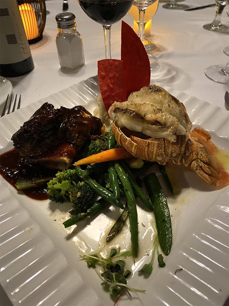 Lobster tail entree with asparagus, broccoli, sprouts and cabbage