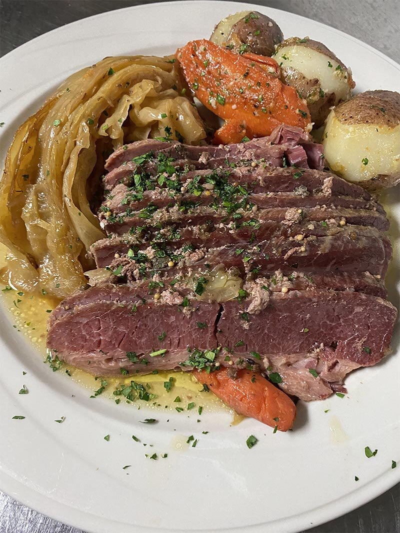Corned beef with a side of cabbage, carrots and potatoes